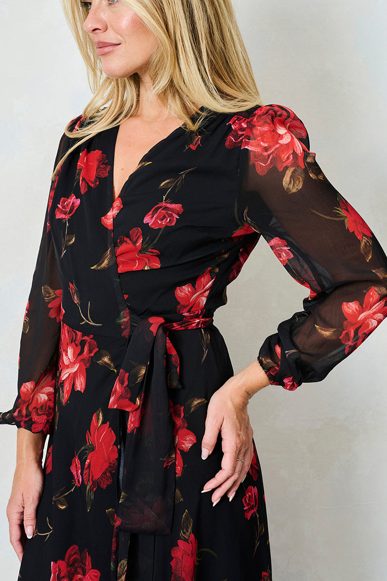 The Camilla Blouson Sleeve Maxi Wrap Dress with Tie Waist
Have heads turning all season long in this classic Hope & Ivy wrap dress – new in for AW25. The Camilla is set to be a seasonal favourite, with bright red, hand-stylised blooms decorating a stylish, chiffon base.